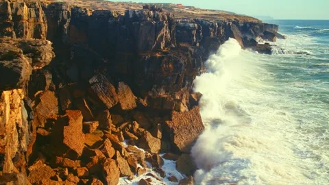Beautiful ocean waves roll and crash onto the rocky shoreline of Portugal. .. Stock Footage 307162661