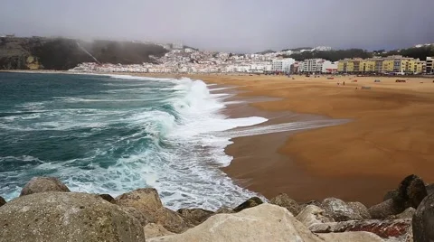 Beautiful ocean waves on sandy beach during misty day, Nazare, Portugal Stock Footage 67817142