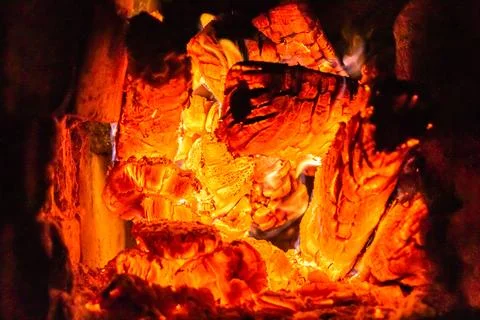 Beautiful old fireplace with light flame fire for heating building room Stock Photos