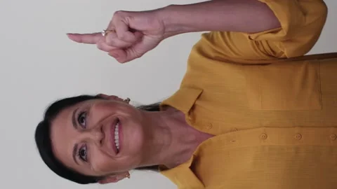 A beautiful old lady points to the top of the screen with two fingers. Stock Footage 145883334