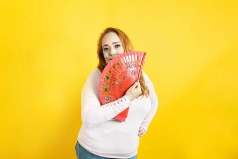 Beautiful old model using hand fan to end the summer heat. Spanish Fotos Stock