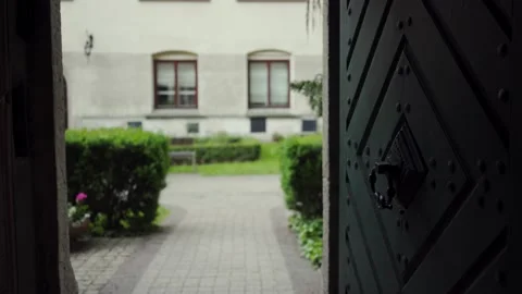 Beautiful old open door through which you can see courtyard with green garden 库存影片 130570261