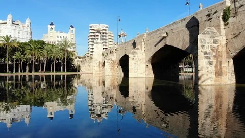Beautiful old stone bridge with a small pond under and perfect water reflection Stock Footage 88174628