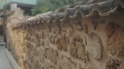 Beautiful old stone fence in a European city. The atmosphere of an old town at Stock Footage 221021704