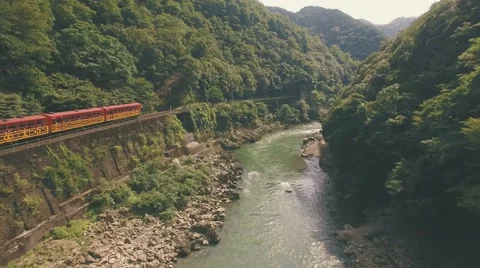 Beautiful old train through Kyoto Mountains Aerial riverside moving aerial 4k Vídeo Stock 67352041