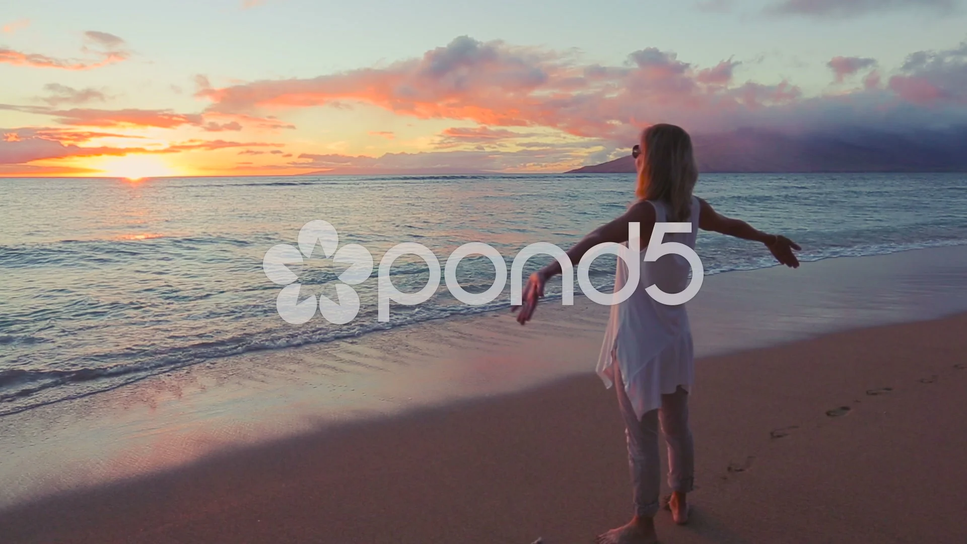 Beautiful Older Woman Enjoying a Sunset Walk on the Beach.