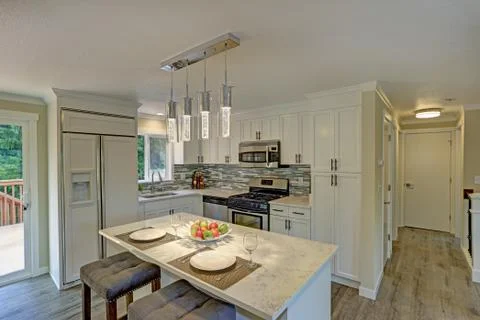 Beautiful open plan second floor white kitchen with traditional style kitchen Stock Photos