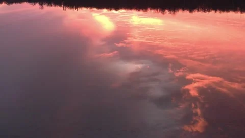 Beautiful orange and gray cloud reflection in water surface, widens Video stock 267097494