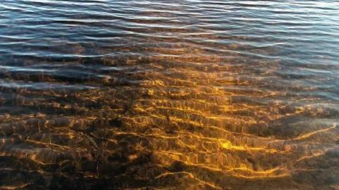 Beautiful orange bottom of the river through the transparent water in Slow Видео 116465726