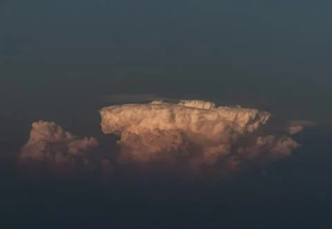 Beautiful orange clouds with dramatic light and blue sky. Stock Photos