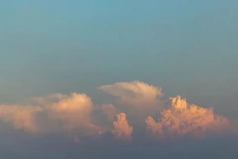 Beautiful orange clouds with dramatic light and blue sky. Stock Photos