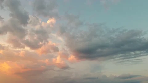 Beautiful orange clouds move in the sunlight against the blue sky. Stock Footage 157924904