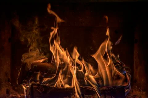 Beautiful orange flames comming from burning birch logs in open fireplace. Stock Photos