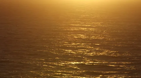 BEAUTIFUL ORANGE SUNLIGHT OVER OCEAN SCENE; SUNSET/SUNRISE; NEGATIVE SPACE; WIDE Stock Footage 59071033