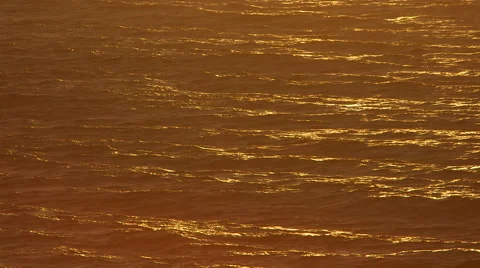 BEAUTIFUL ORANGE SUNLIGHT OVER OCEAN; SUNSET/SUNRISE; NEGATIVE SPACE; CLOSE UP Stock Footage 59071136