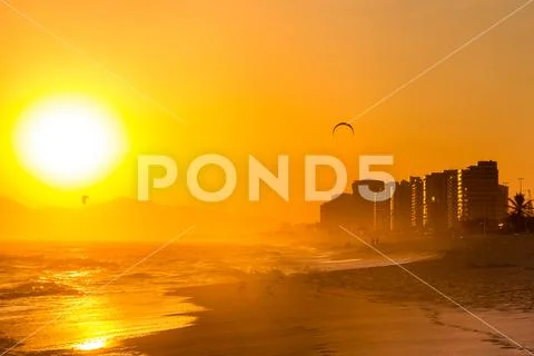 Beautiful orange sunset in barra da Tijuca beach, rio de janeiro Stock Photos