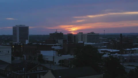 Beautiful orange sunset over a small rundown southern town Video stock 130991066