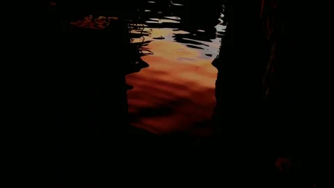 Beautiful  Orange Sunset reflected By Water In The Dask Stock Footage 155980125