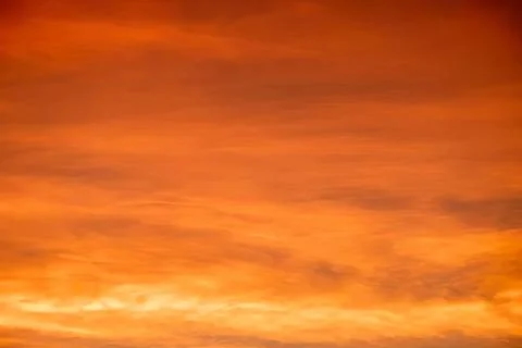Beautiful orange sunset sky with clouds at dusk Stock Photos