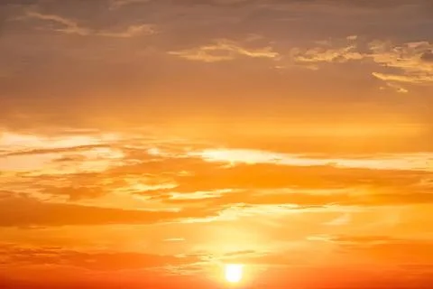 Beautiful orange sunset sky with clouds at dusk Stock Photos