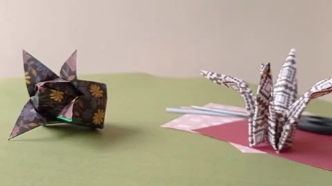 A beautiful origami bird on a table Stock Footage 150666439