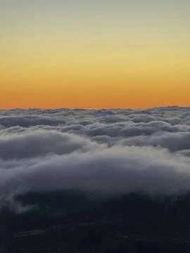 Beautiful over the clouds view with sunset sky Stock Photos