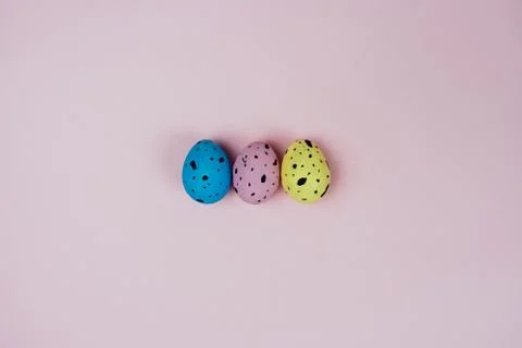 Beautiful painted Easter eggs isolated on pink background. Quail eggs. Happy Stock Photos