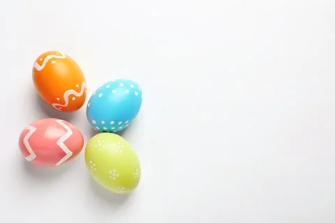 Beautiful painted Easter eggs on white background, top view Foto stock