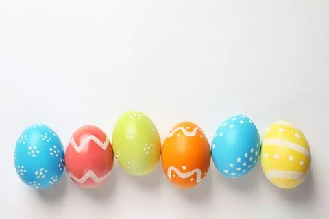 Beautiful painted Easter eggs on white background, top view Stock Photos