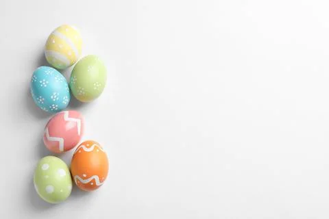Beautiful painted Easter eggs on white background, top view Stock Photos