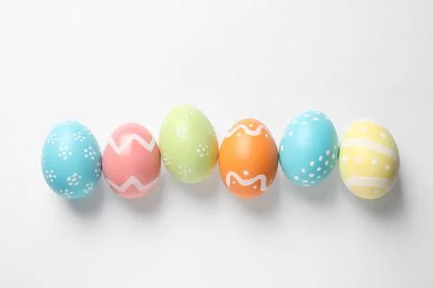 Beautiful painted Easter eggs on white background, top view Stock Photos