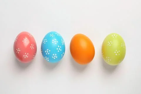Beautiful painted Easter eggs on white background, top view Stock Photos