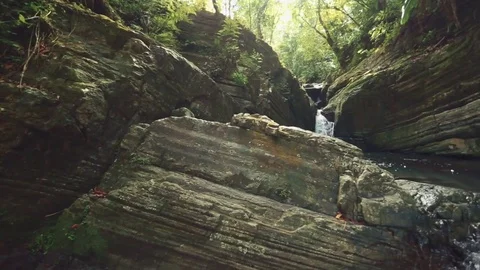 Beautiful pan shot of a River with big Rocks Stock Footage 79734255