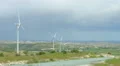 Beautiful pan of summer field, green hills, wind farm generating electricity 4k or 4k+ Resolution