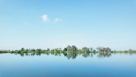 Beautiful panoramic river landscape with trees and reflections on the calm .. Stock Footage 345040033