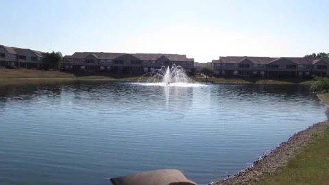 Beautiful panoramic view of apartment complex pond &amp; fountain hot summer morning Stock Footage 201500550