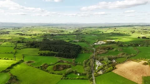 A beautiful, panoramic view reveals patchwork fields and rolling hills Stock Footage 316525451