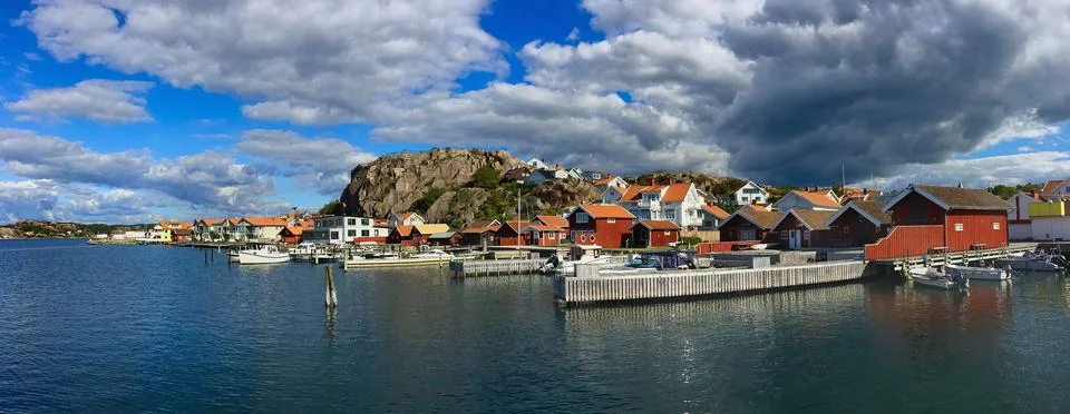 Beautiful panoramic view on a swedish typical  town at seaside under cloudy s Stock Photos