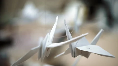 Beautiful paper birds dangle in the wind under the roof. Handmade birds Stock-Footage 197741983