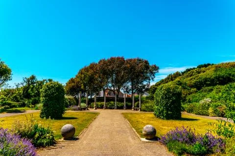 Beautiful park in antique style, stone decorations on pedestals, beautiful Stock Photos