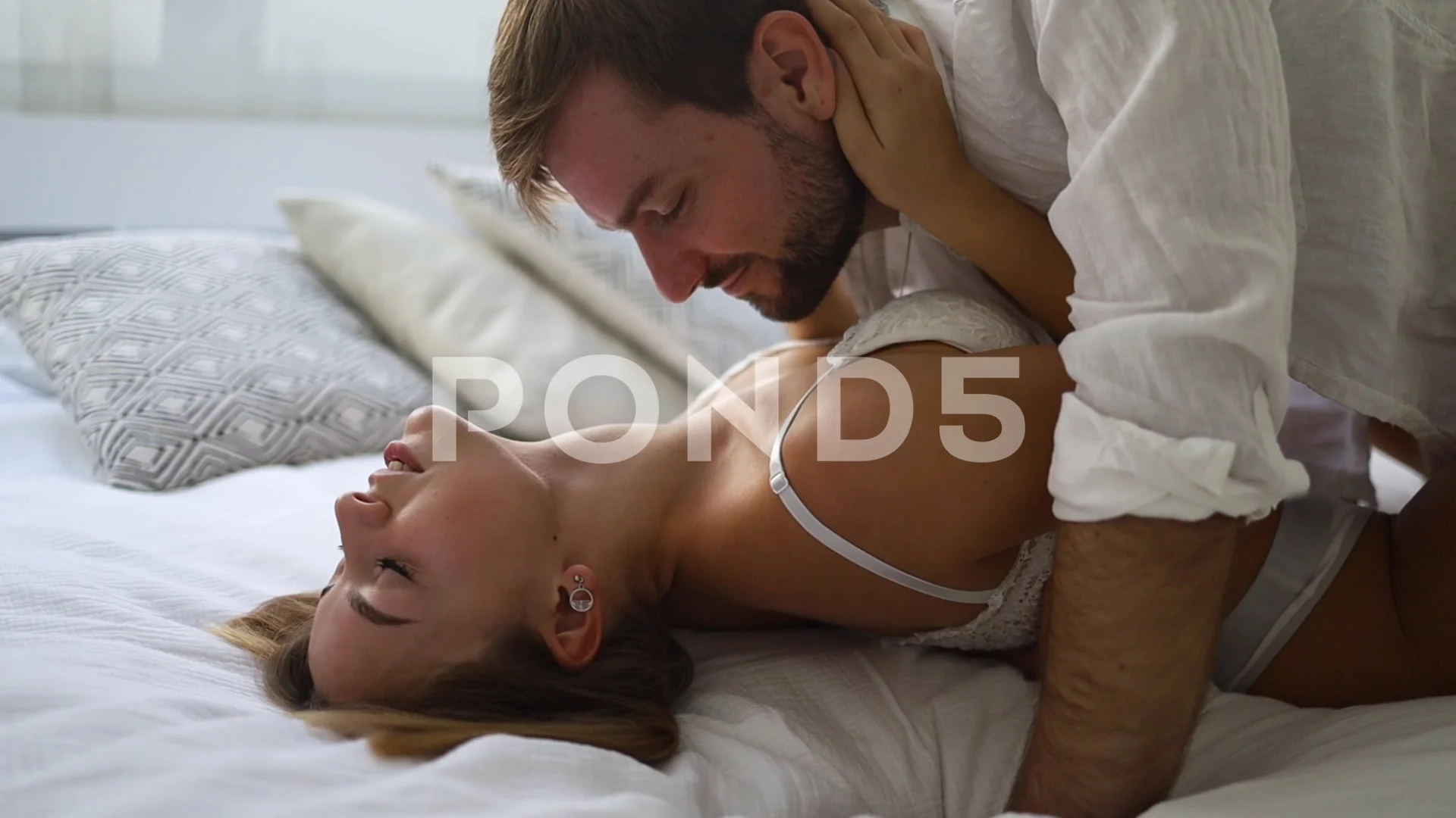 Beautiful passionate couple having sex on the bed.