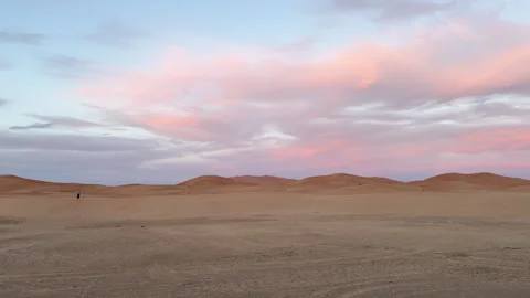 Beautiful pastel-colored clouds moving over the Sahara Desert sand dunes Stock Footage 332768289