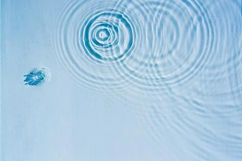 Beautiful pattern of circles of drops on background of water 写真素材