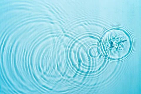Beautiful pattern of circles of drops on a background of water Stock Photos