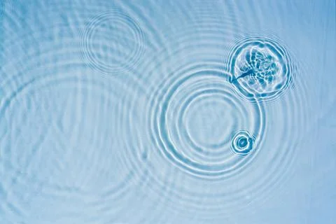 Beautiful pattern of circles of drops on background of water Stock Photos