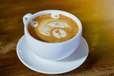 Beautiful pattern in the form of bear in a white cup with a latte maded in th Stock Photos