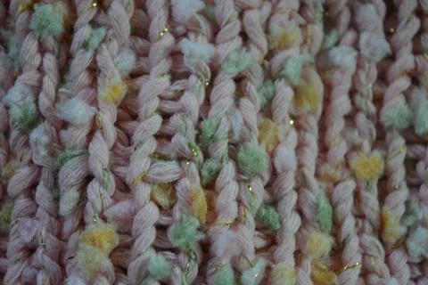 A beautiful patterned background is knitted from pink threads, colored inserts. Foto stock