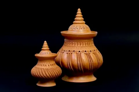 Beautiful patterned pottery isolated on a black background. Stock Photos