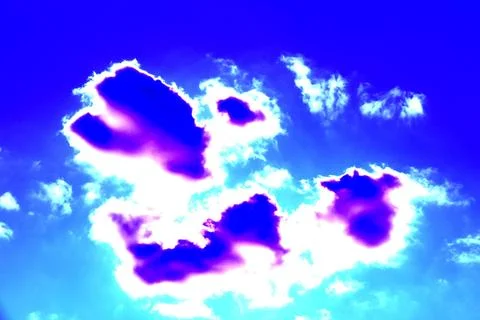 Beautiful patterns of clouds on a clear sky background. Changed color scheme. Stock Photos