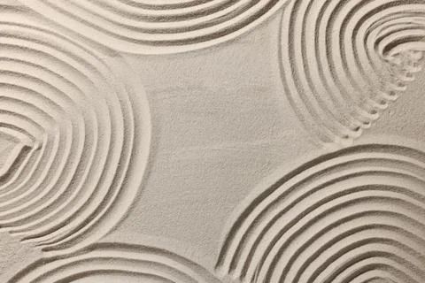 Beautiful patterns drawn on sand, top view. Zen garden Stock Photos